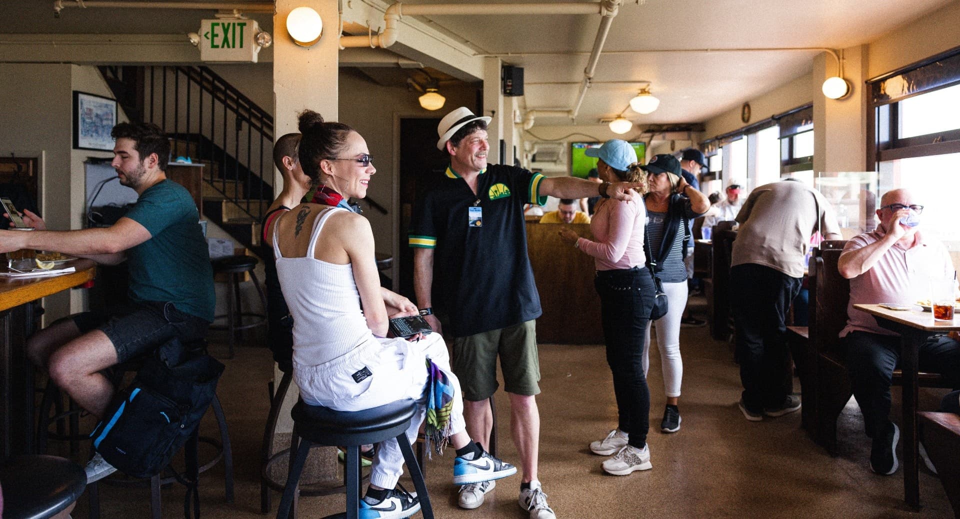 Group on indoor food tour in crowded cafe enjoying samples