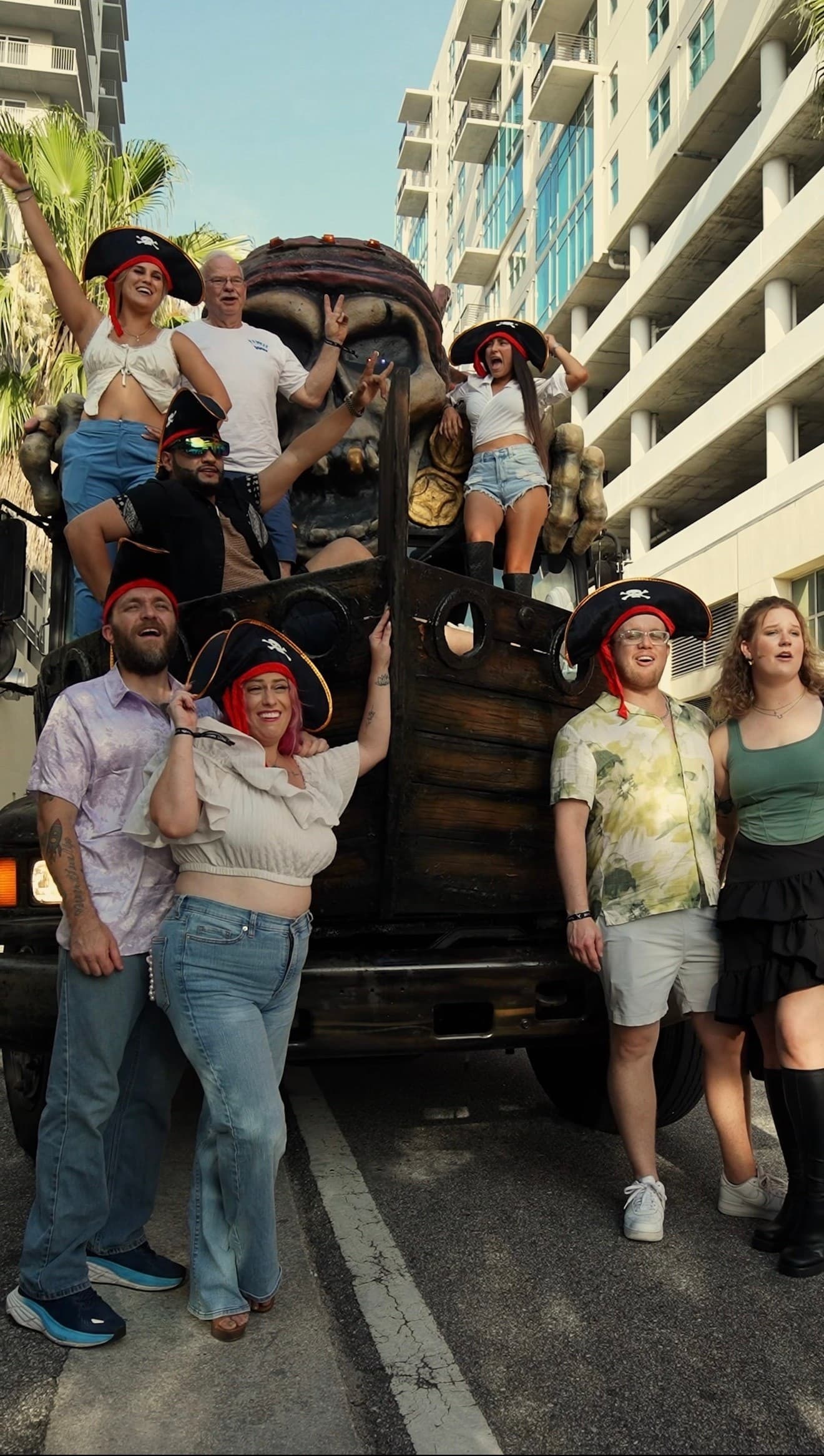 Group posing on pirate party bus during outdoor Tampa pub crawl