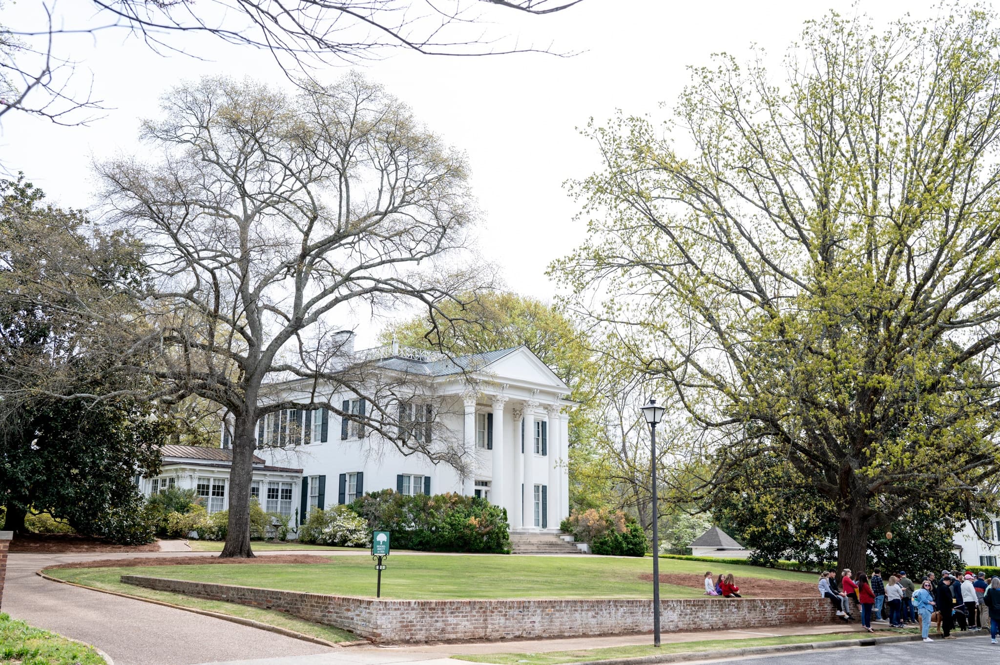 Historic plantation mansion with oak trees on outdoor tour