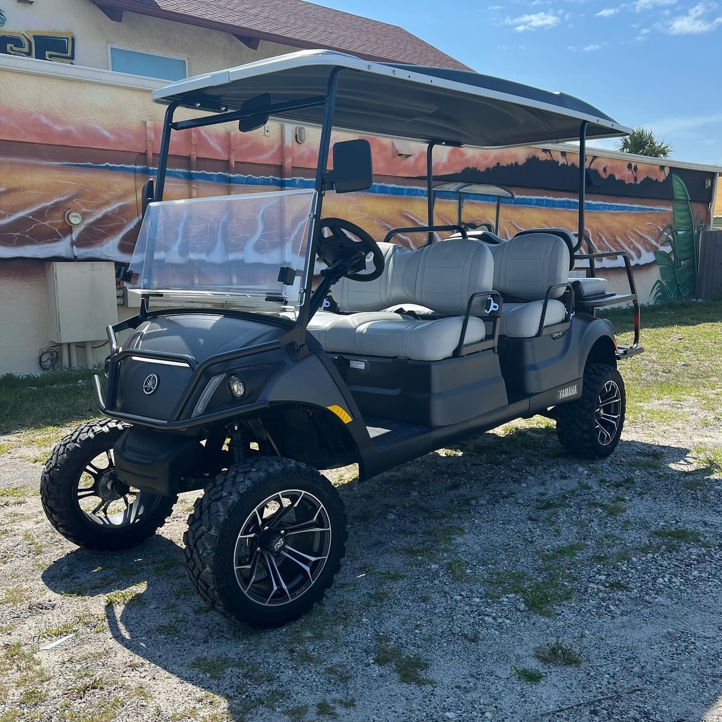 Six-seat lifted golf cart for beach tours in Florida sand