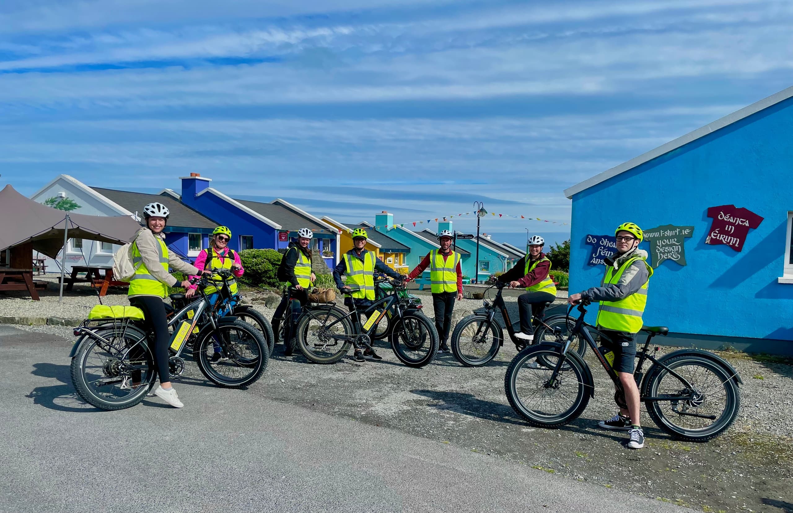 Fat-bike group assembling in colorful coastal village near Galway harbor