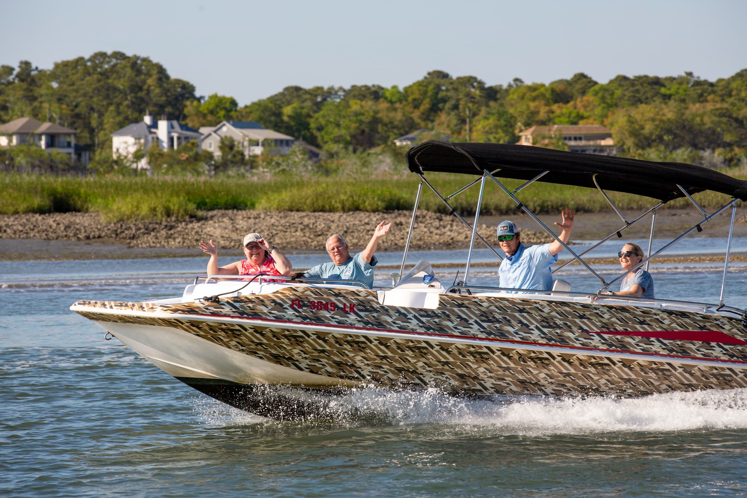 High-speed powerboat cutting through water, coastal thrill ride