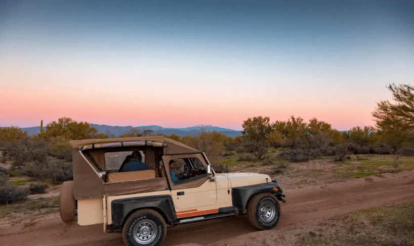 Sunset Jeep safari on desert trail showcasing open-air adventure