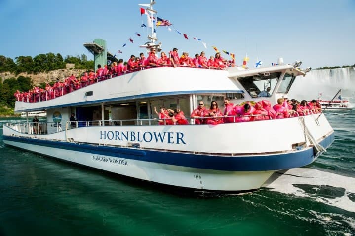Hornblower tour boat packed with passengers at Niagara Falls