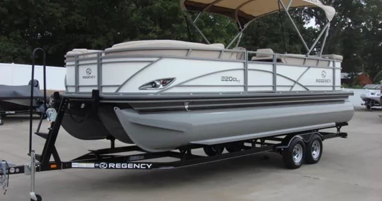 Pontoon boat on trailer at lakeside rental ready for boating