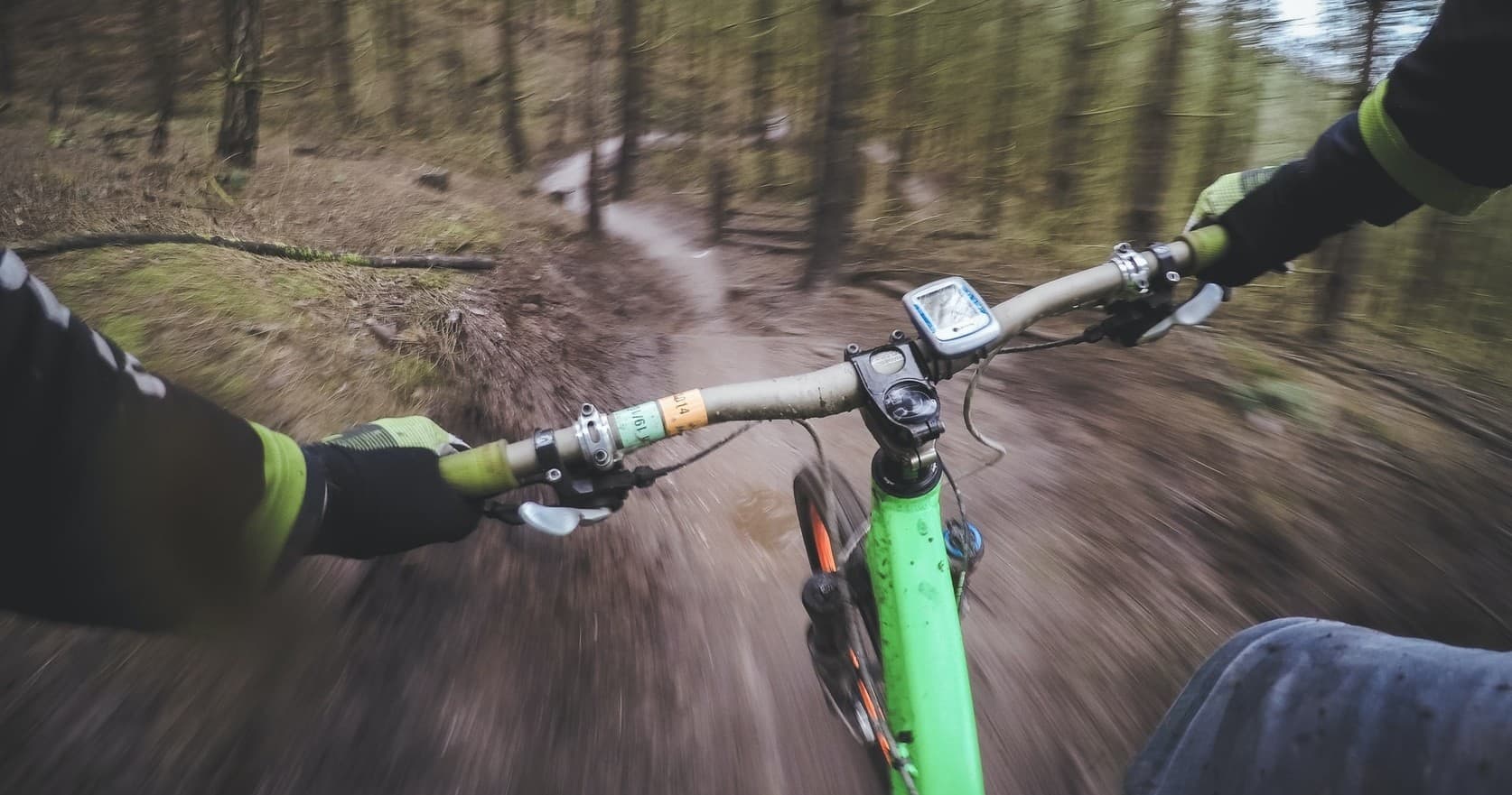 POV mountain bike trail ride at speed through wooded singletrack