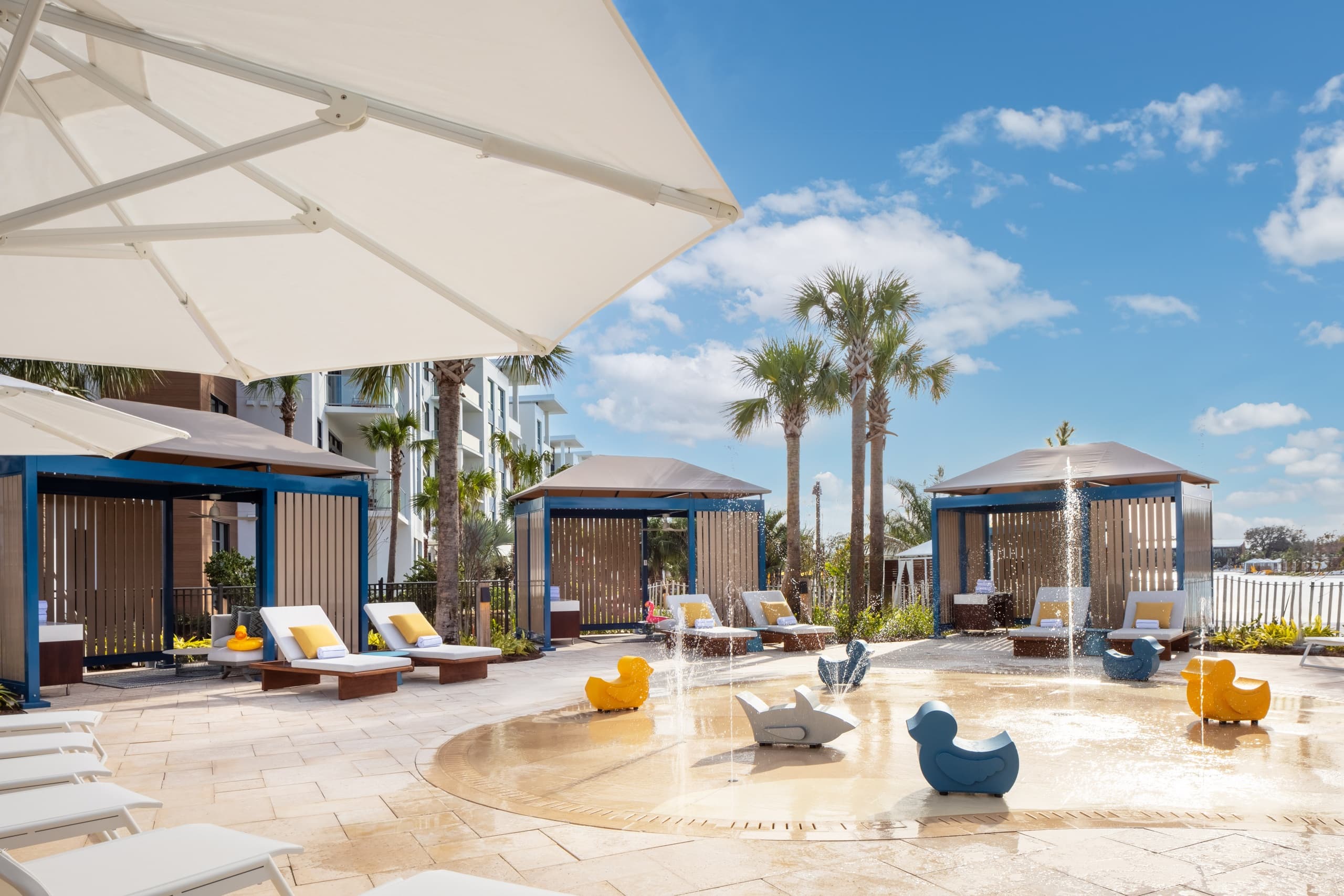 Oceanfront pool deck with cabanas and sun loungers at resort
