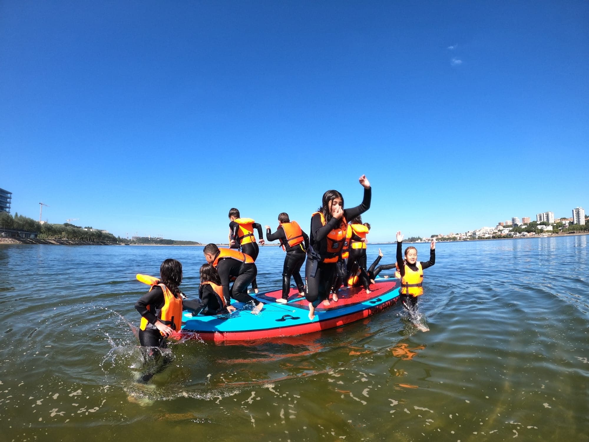 Group paddling excursion in inflatable boat on coastal estuary