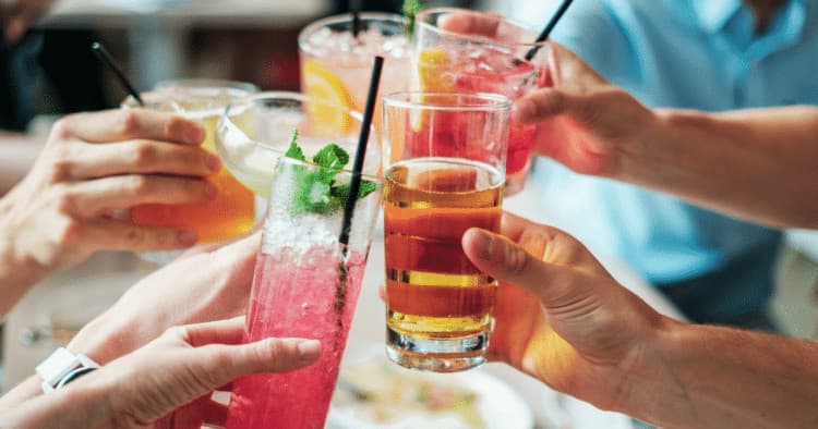 Friends toasting cocktails during a Texas food tour