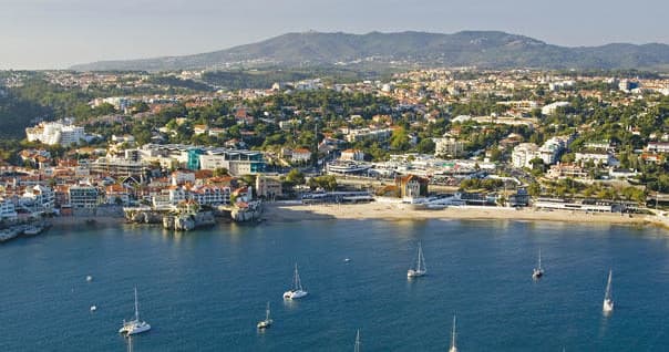 Aerial coastal bay view with boats and seaside town panorama