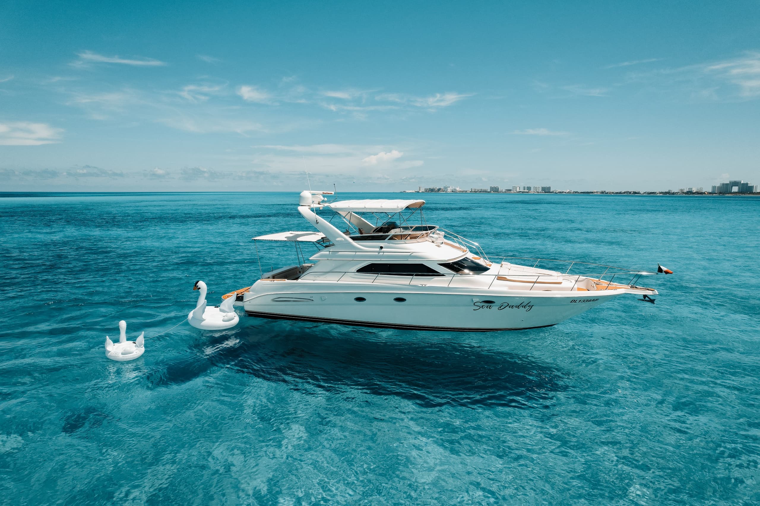 Luxury yacht cruising turquoise Caribbean waters, aerial seascape
