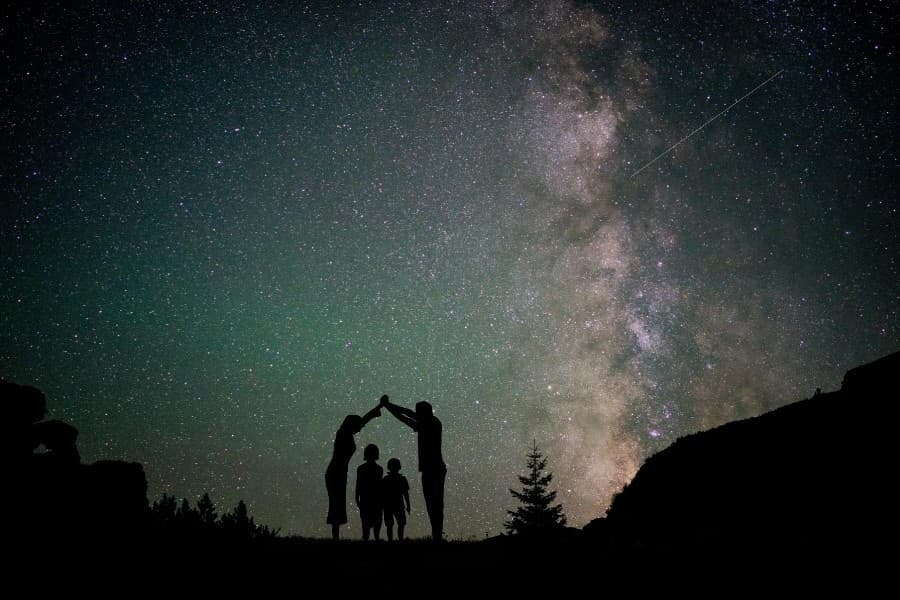 Family stargazing under Milky Way on Tenerife volcanic night