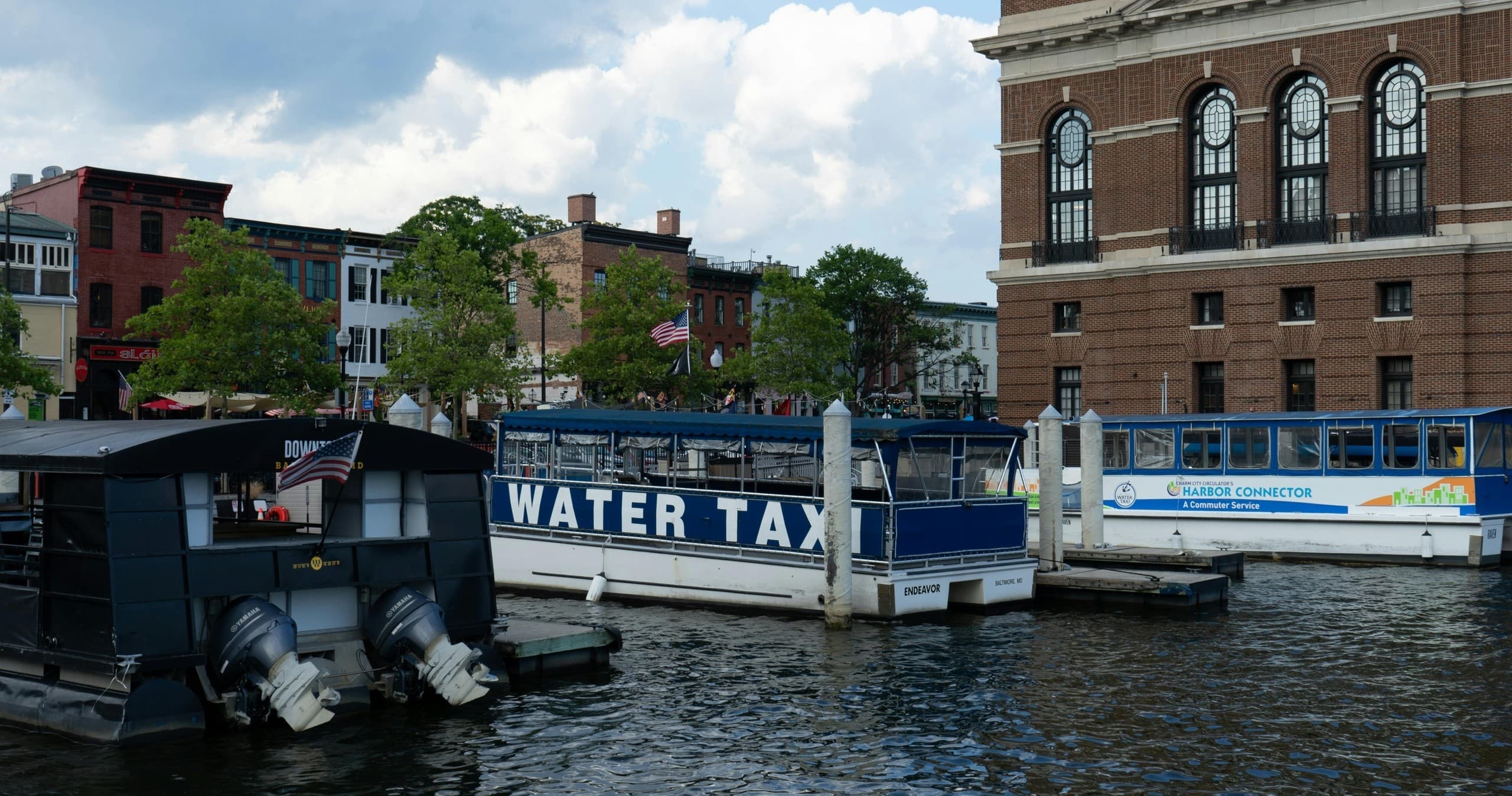 Water taxi docked at urban harbor waterfront, scenic city boat ride