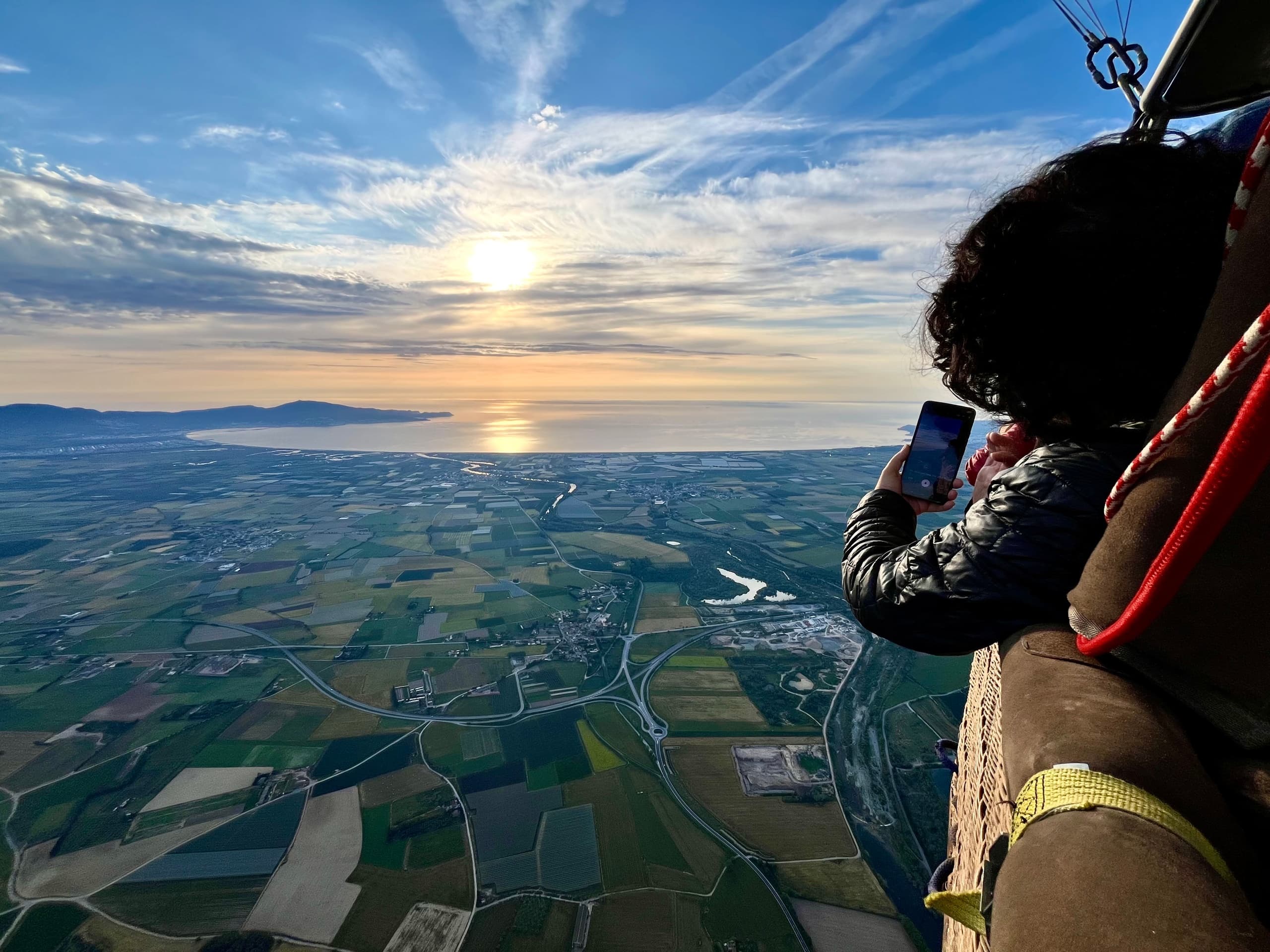 Sunset flight view from balloon basket over coastal plain, Emporda adventure