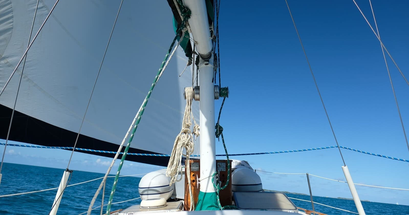 Sailing on deck in clear tropical sea, daytime horizon