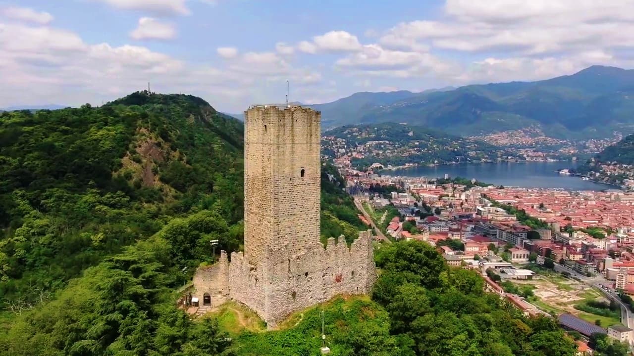 Medieval castle tower on hillside above town, scenic ruin