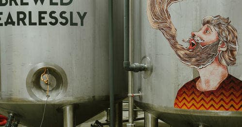 Color mural and brewing tanks in Drygate brewery production hall