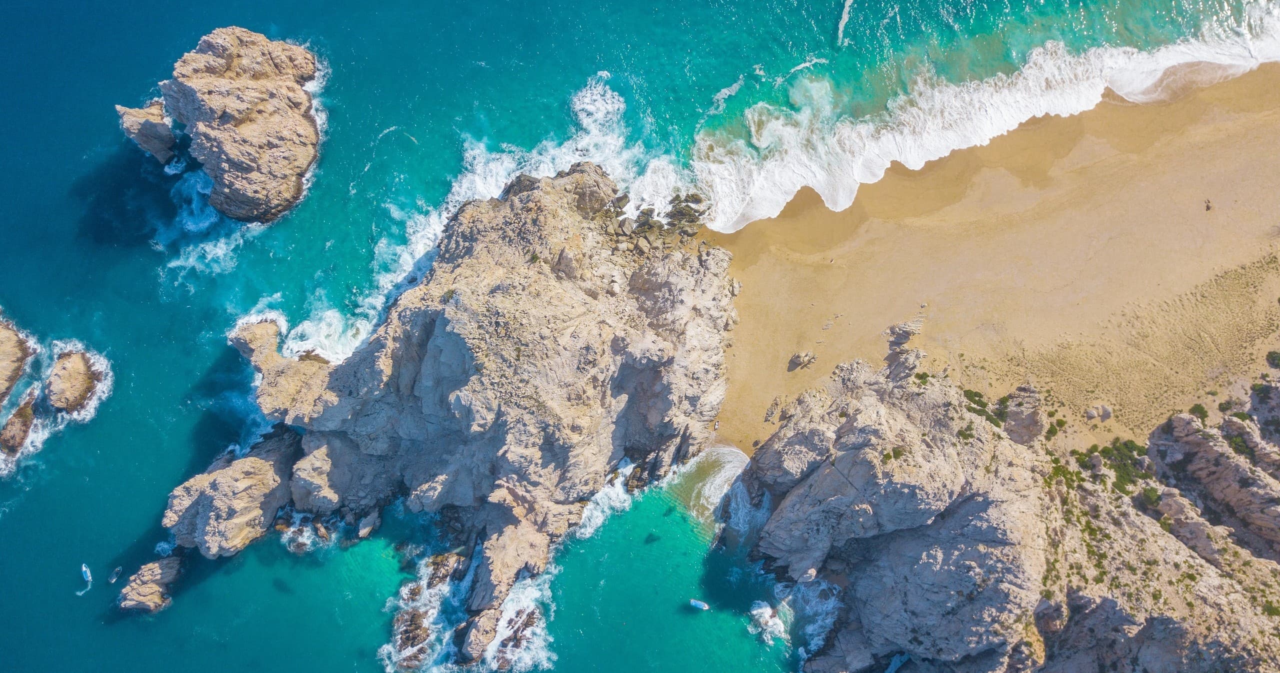 Aerial tropical beach with turquoise water and rocky coves