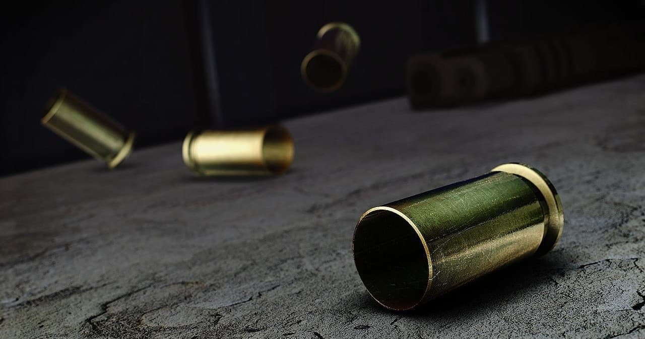 Spent brass casings scattered on concrete at shooting range practice