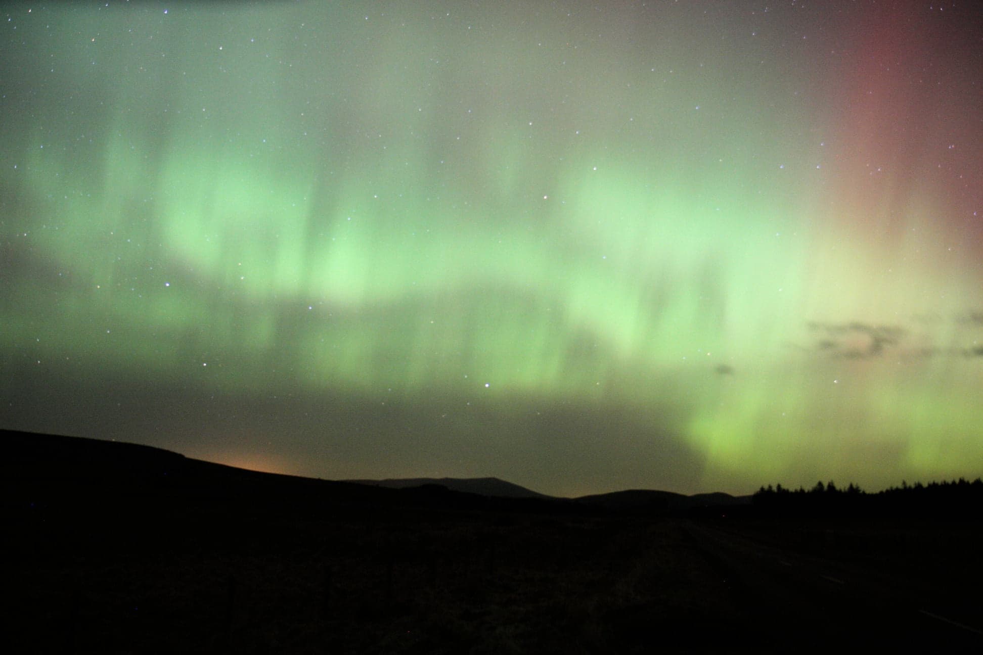 Aurora borealis over remote Arctic landscape for nighttime skywatching