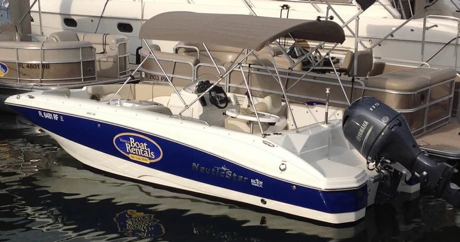Deck boat moored at marina in sunny coastal waters