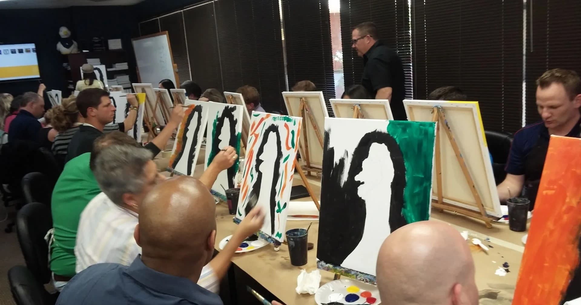 Group painting session in community art studio, indoor