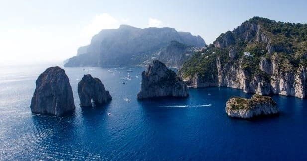 Faraglioni sea stacks off Capri island, scenic boat viewing tour