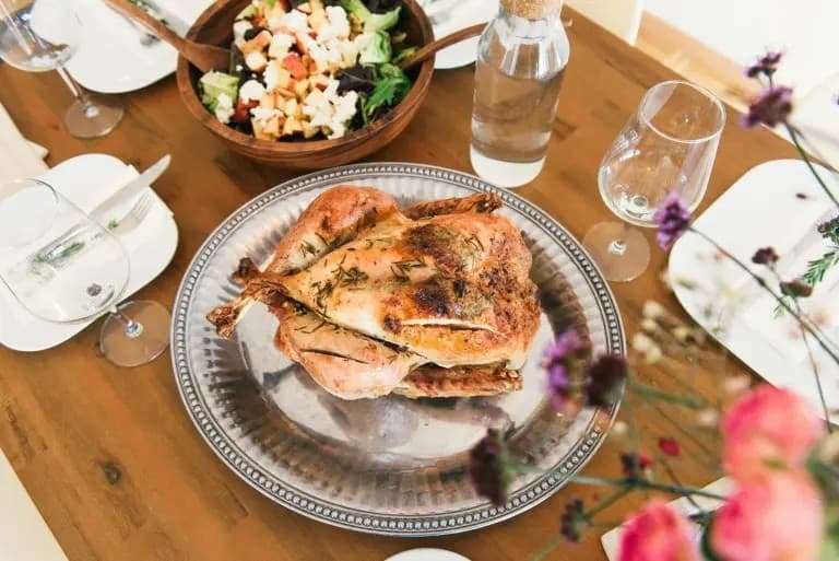 Roasted turkey on decorated dining table, holiday family feast