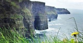 Cliffside coastal hike along dramatic sea cliffs in Ireland