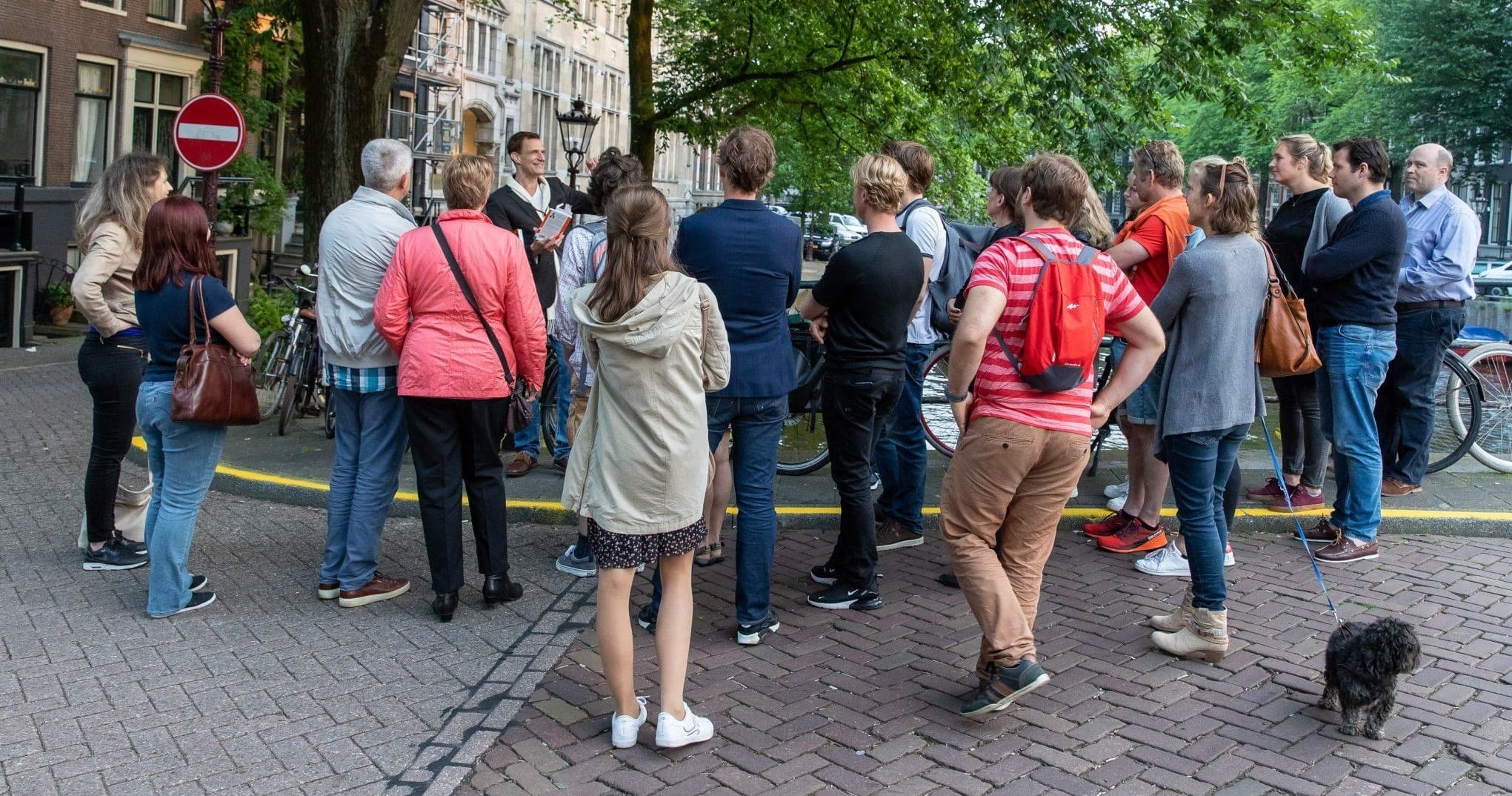 Walking tour group gathered on historic DC street sidewalk