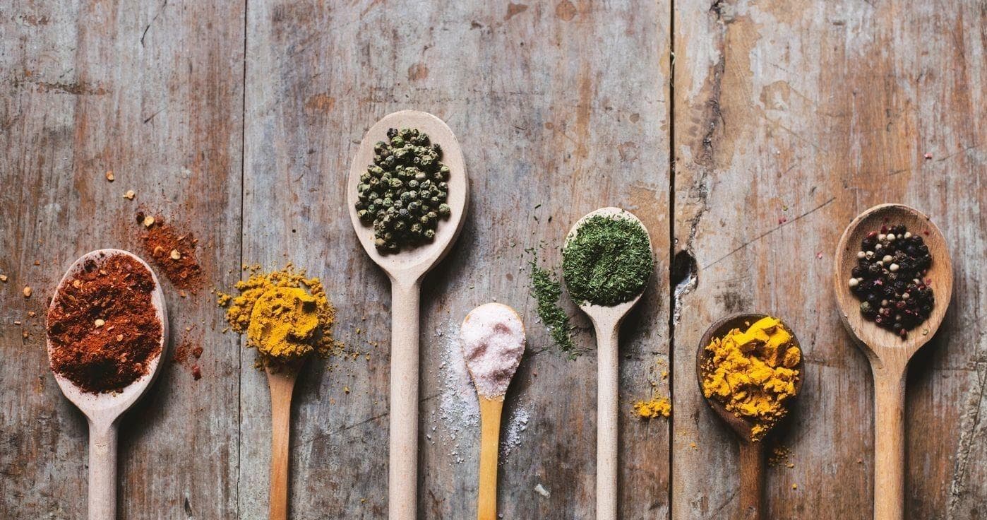 Assorted spices on wooden spoons for Jasper culinary tour