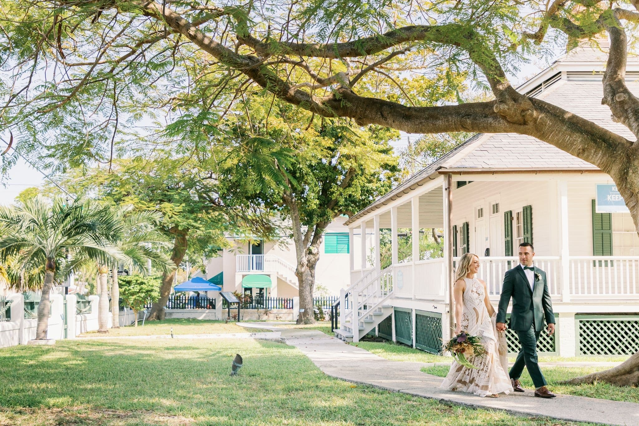 Couple strolling historic coastal garden with colonial cottages