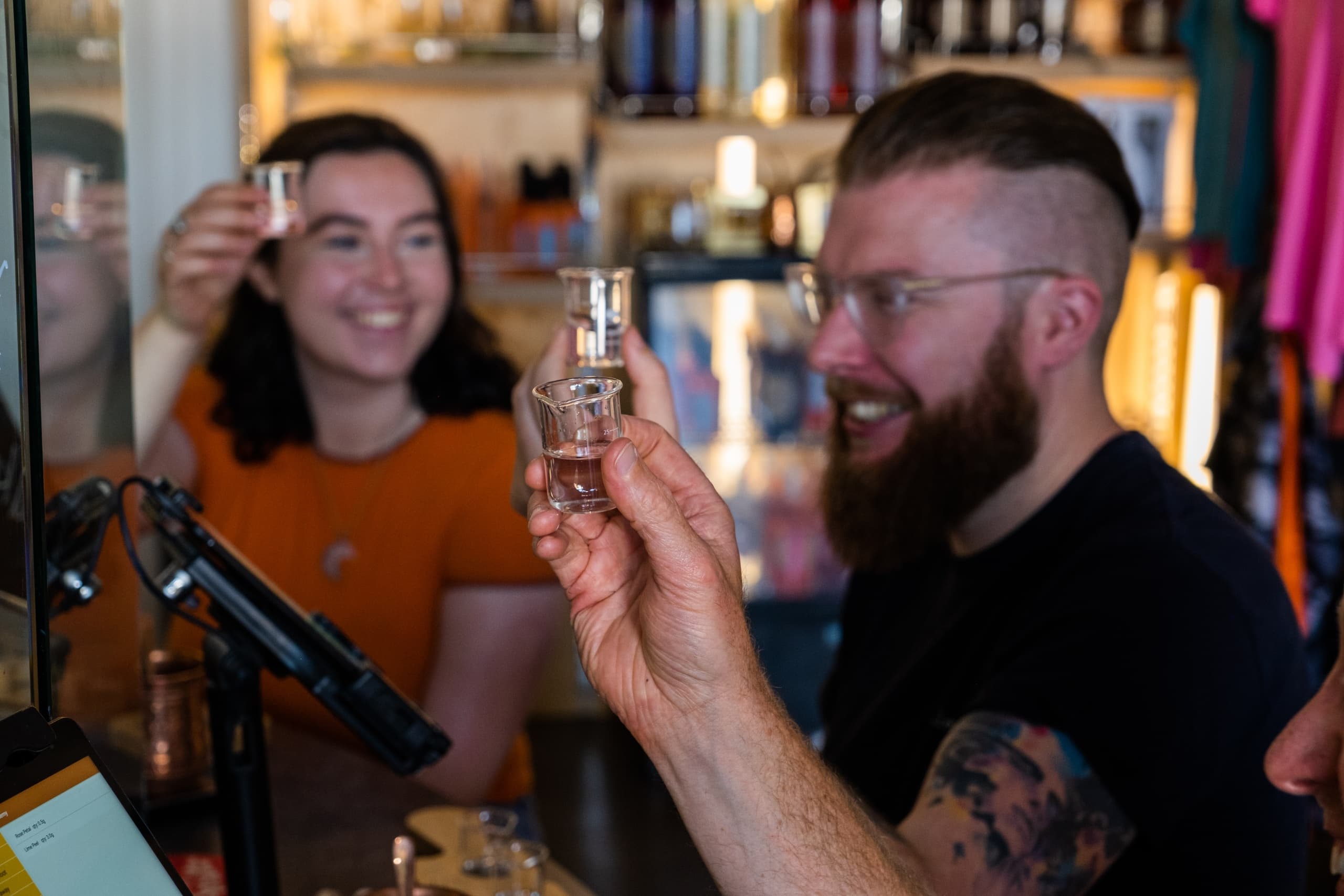Patrons sampling spirits at Stillgarden distillery tasting bar