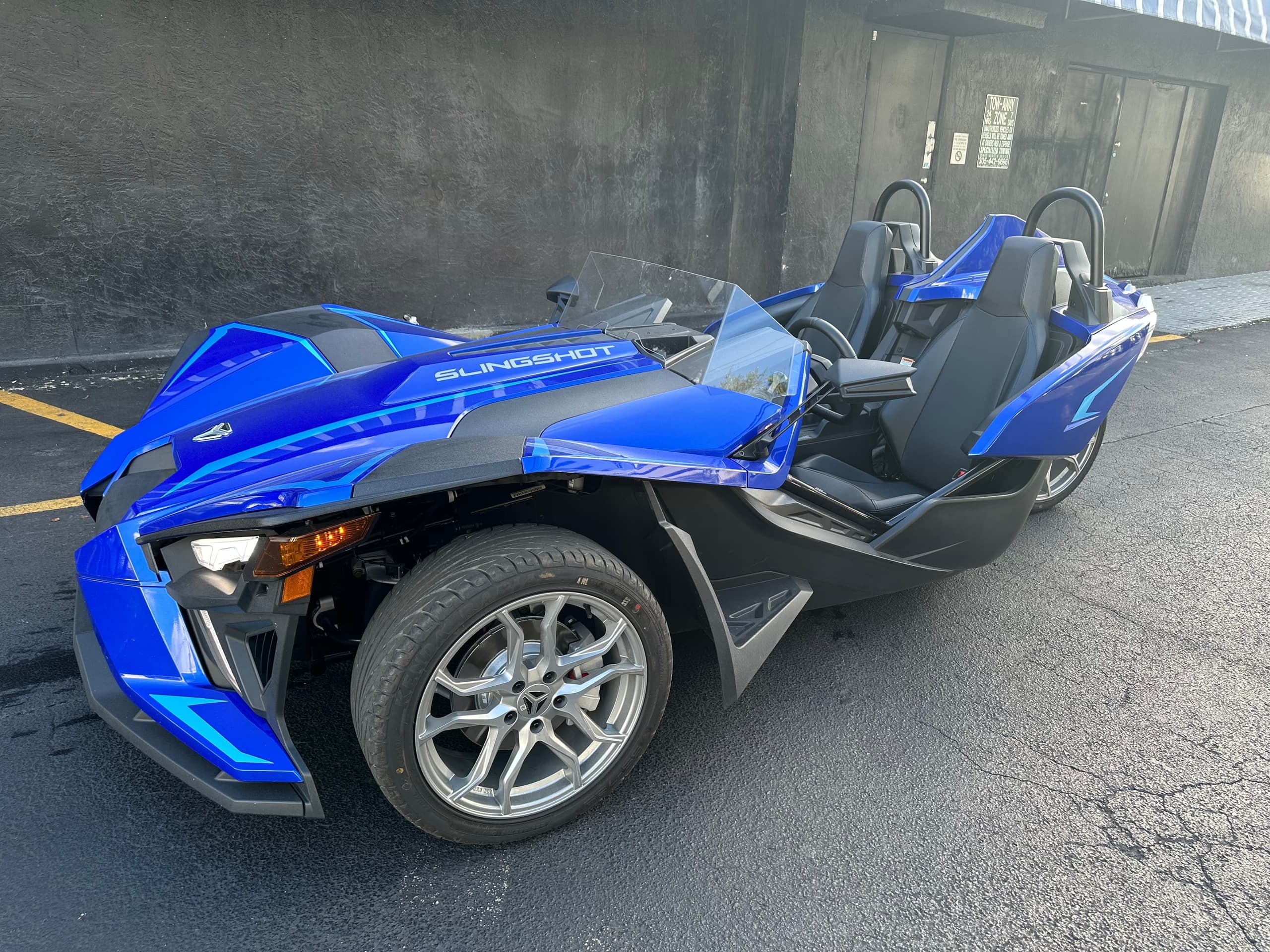 Blue slingshot in urban parking lot, ready for city coastal ride