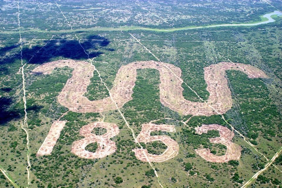 Aerial view of King Ranch branded clearing and Texas landscape