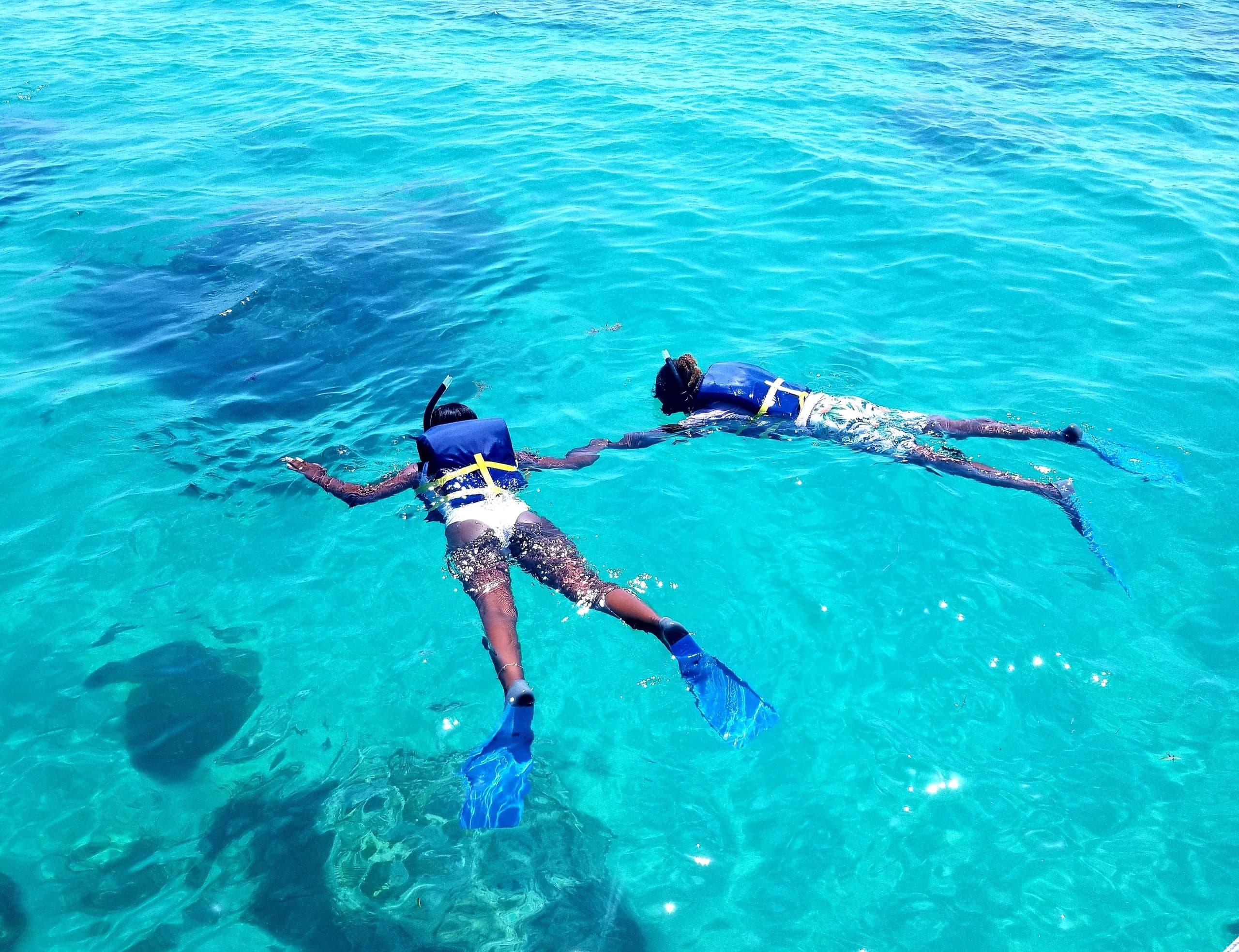 Snorkelers enjoying reef swim in crystal clear Caribbean waters