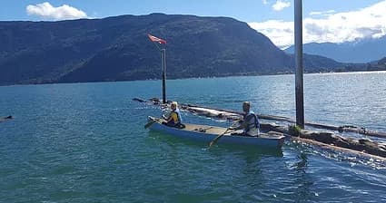Boat cruising on turquoise lake with distant mountain vista