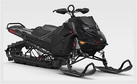 Snowmobile parked on groomed trail, overcast mountain setting