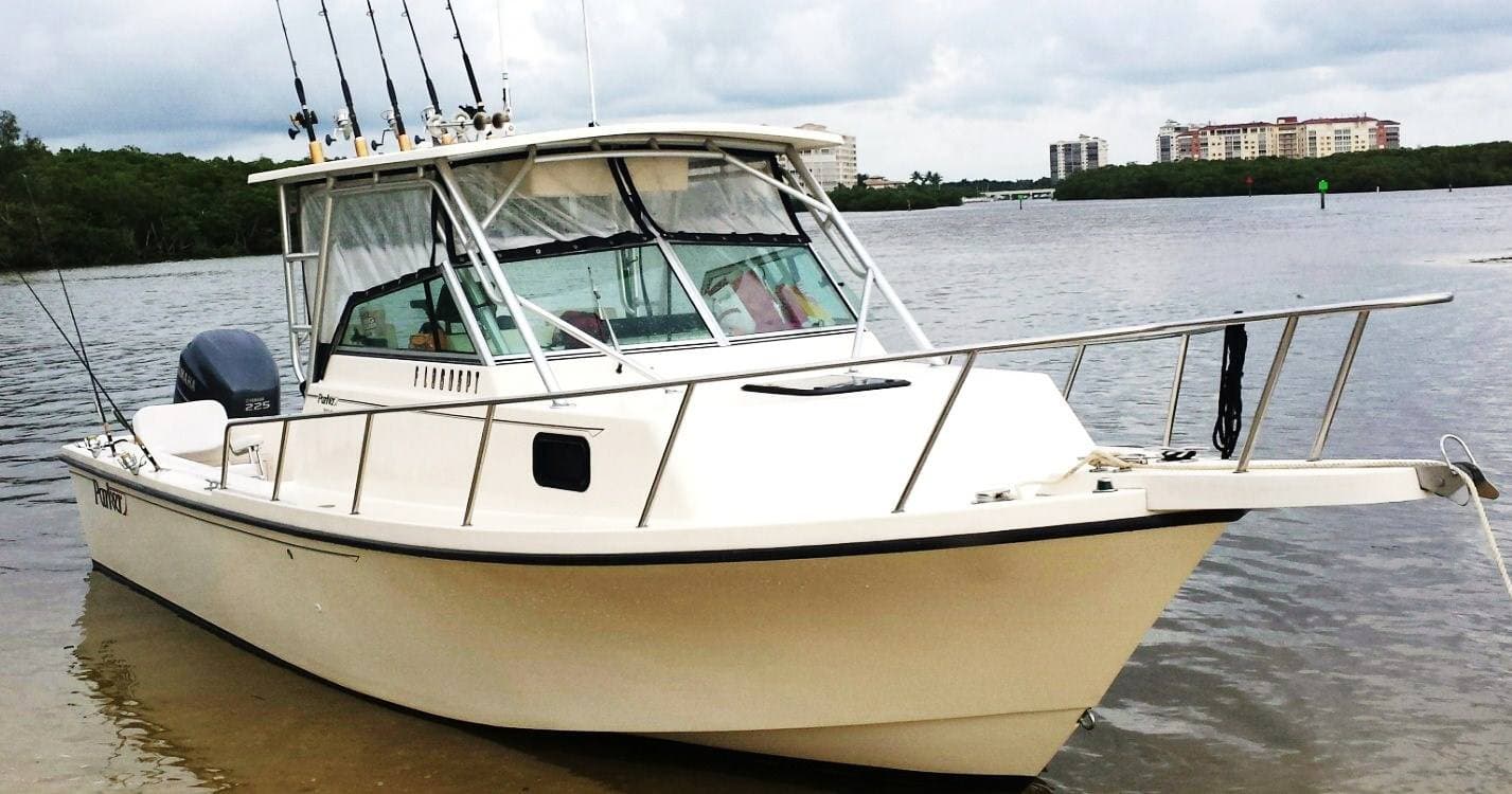 Well-equipped fishing boat anchored near mangrove coastal inlet
