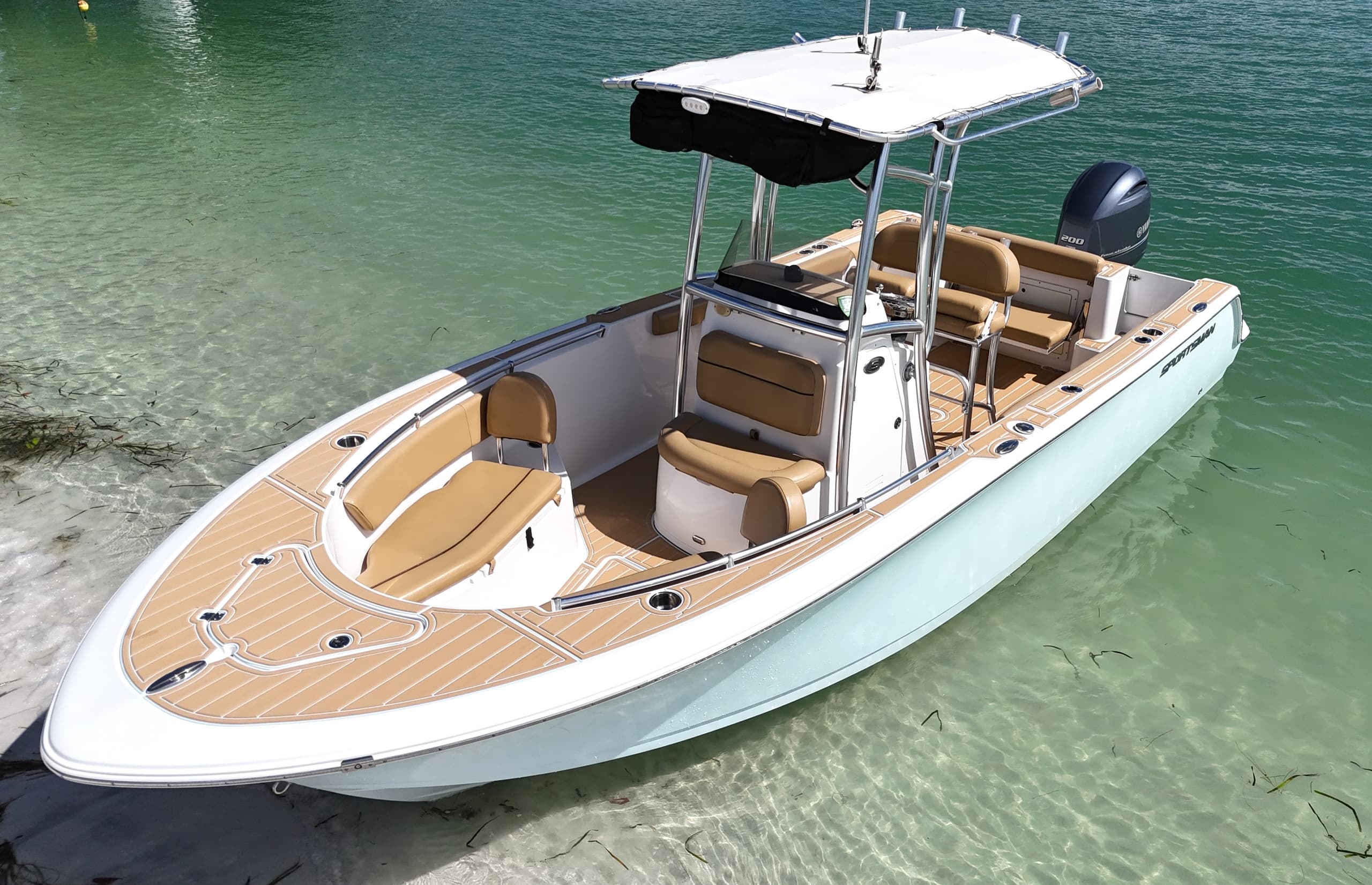 Center console boat anchored in clear water for day charters