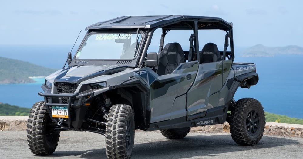 Off-road 4x4 UTV parked at ocean viewpoint on island road