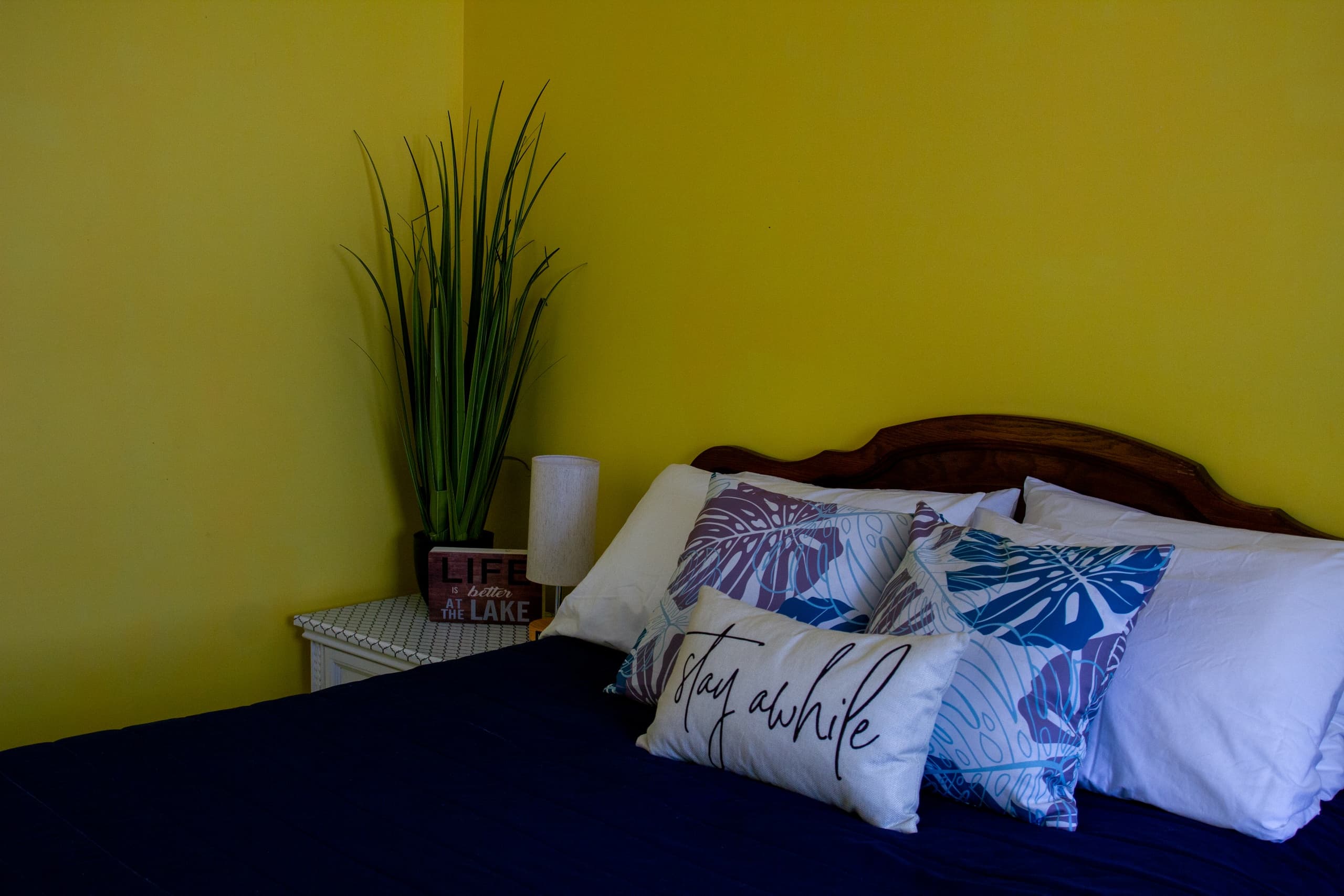 Colorful cabin bedroom with plant accent and relaxed stay vibe