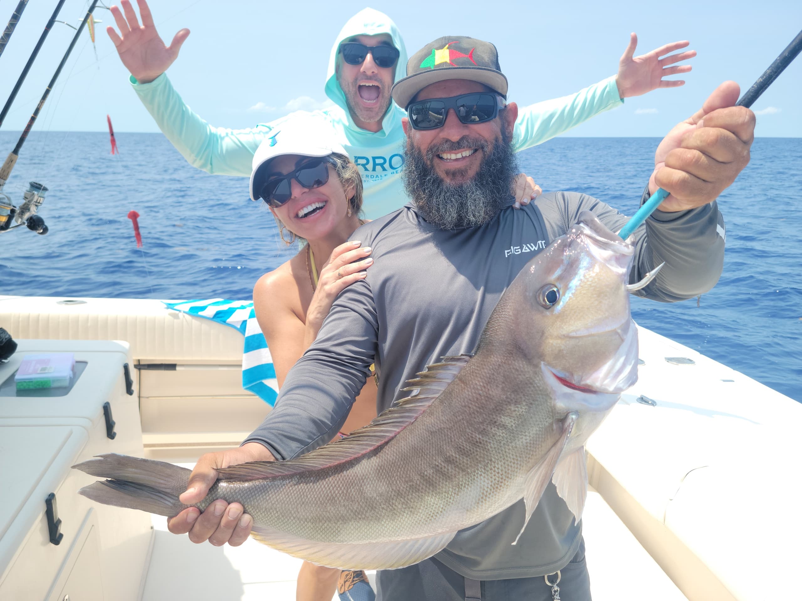 Group celebrating big offshore catch on a bluewater fishing boat