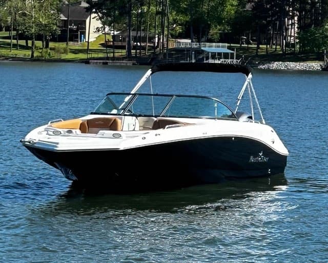 Bowrider speedboat rental gliding across sunny residential lake