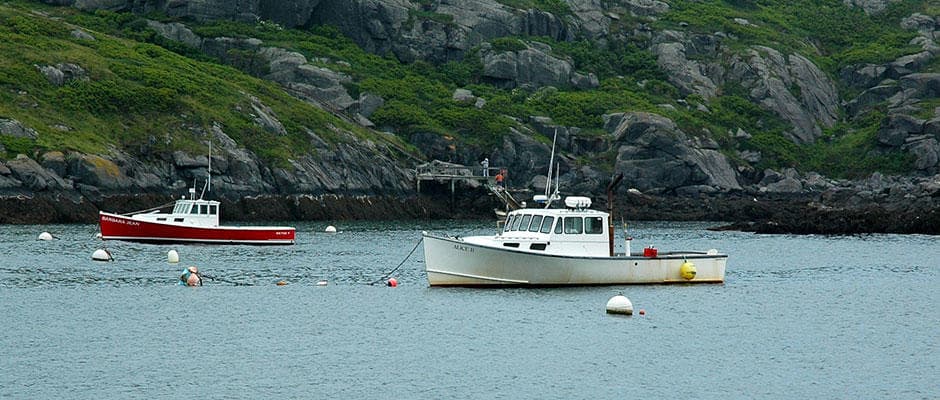 Fishing boats moored in a rocky harbor off Monhegan Island coast