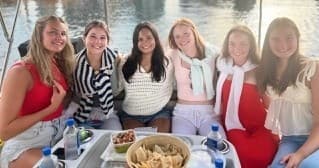 Friends socializing on deck of leisure boat with snacks