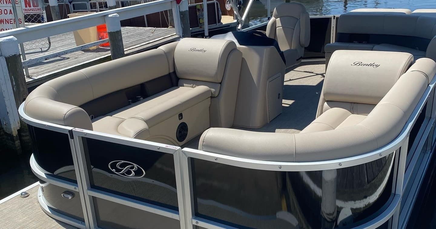 Pontoon boat seating and deck at marina, rental watercraft display