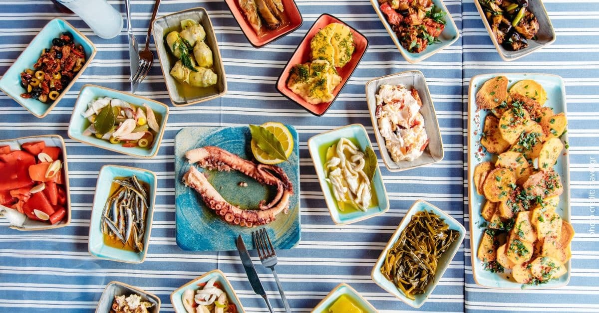 Mediterranean mezze picnic spread on striped outdoor tablecloth