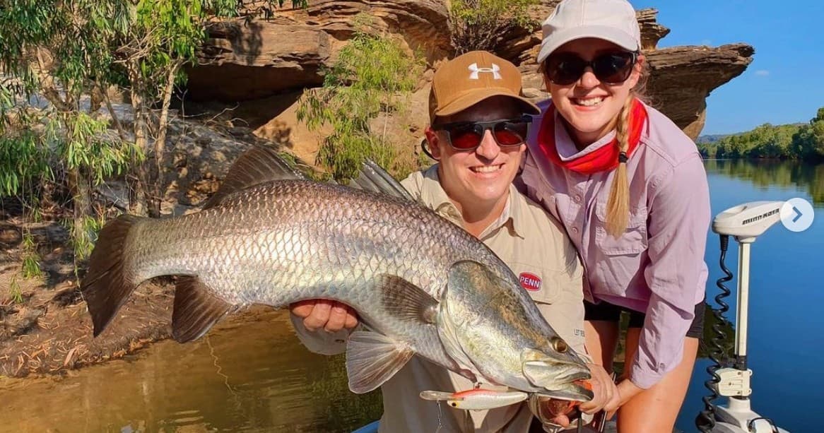 Anglers holding large barra on freshwater river in Kakadu