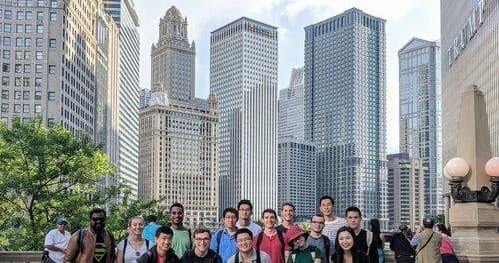 Group walking tour with Chicago skyline along riverfront